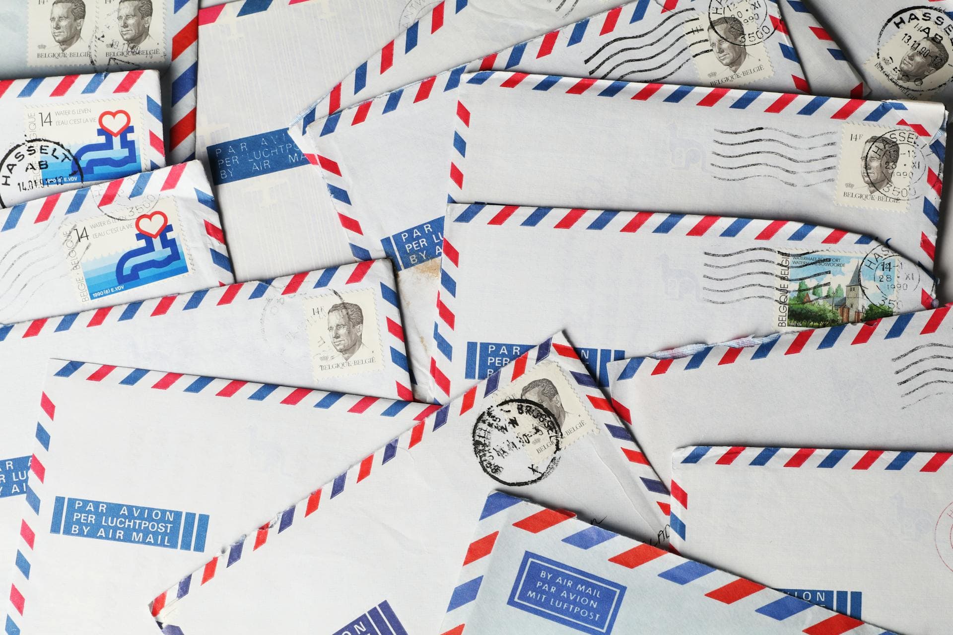 A sealed window envelope of agency correspondence resting on a stack of mail.